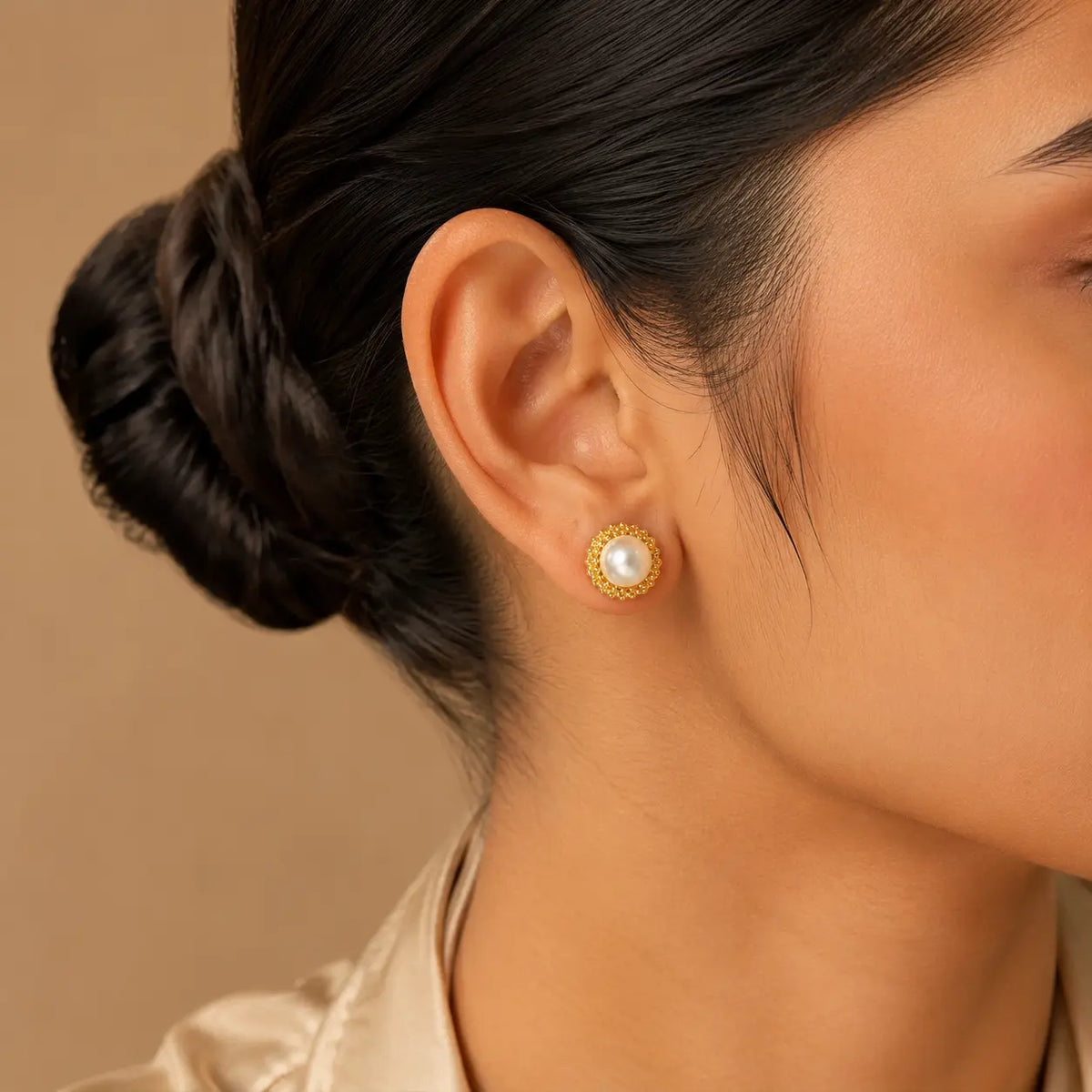 Meher pearl halo stud worn close-up