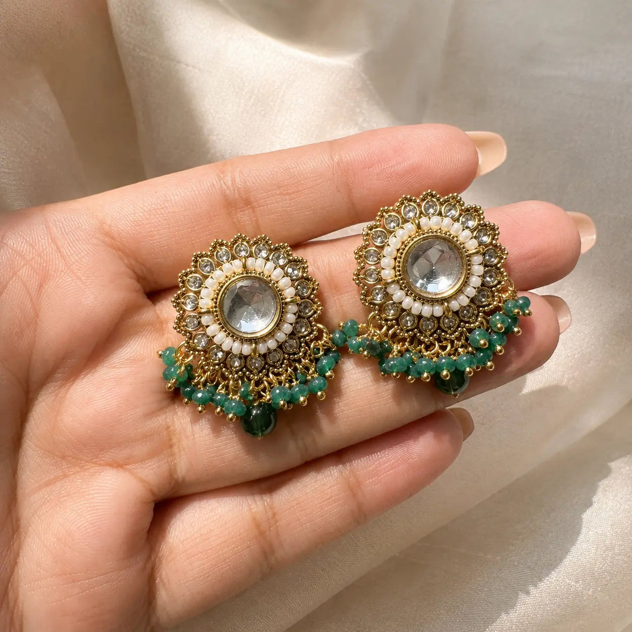 Noorani Green earrings handheld scale view