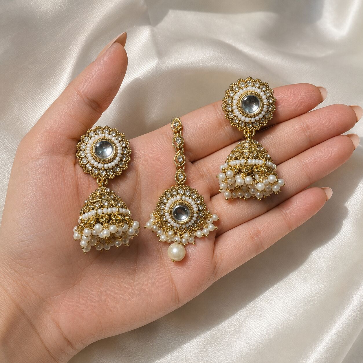 Anaya Pearl Kundan Chandbali Earrings and Teeka Set hand-held view