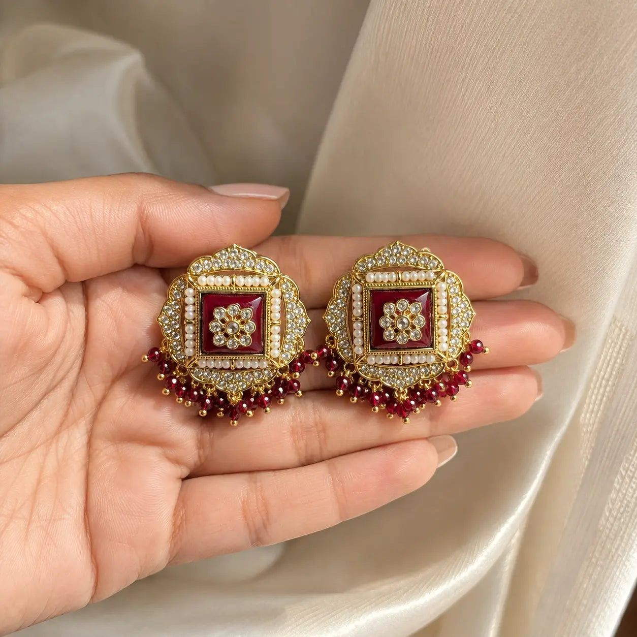 Sahar Kundan Pearl Fringe Stud Earrings - red handheld
