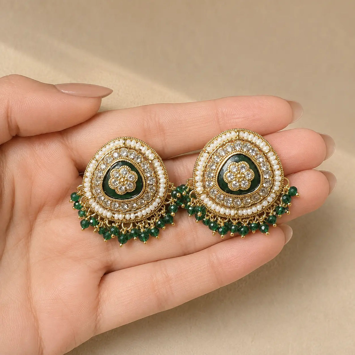 Afsana green earrings handheld scale view
