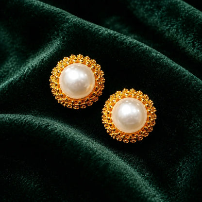 Meher pearl halo studs on emerald velvet