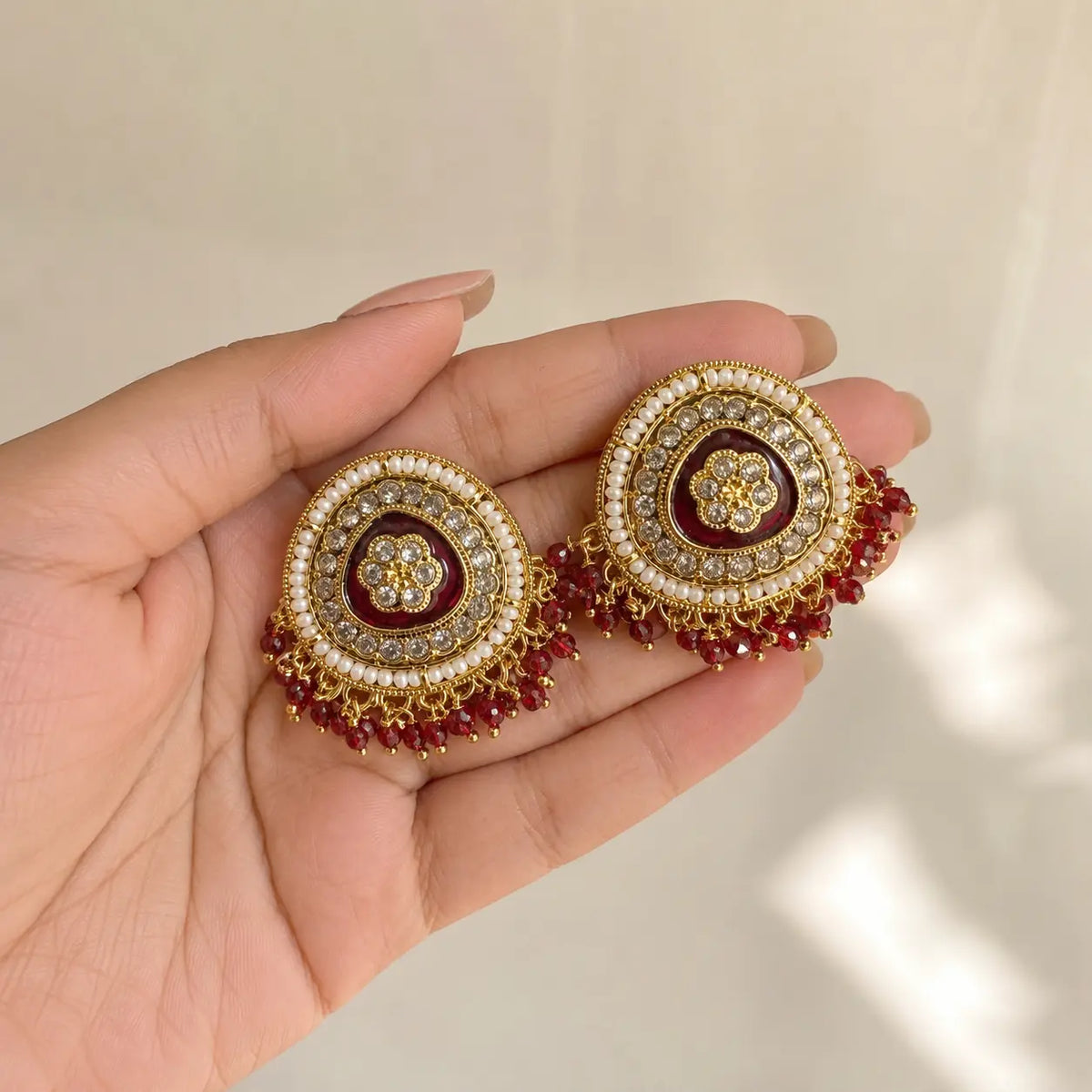 Afsana red earrings handheld scale view